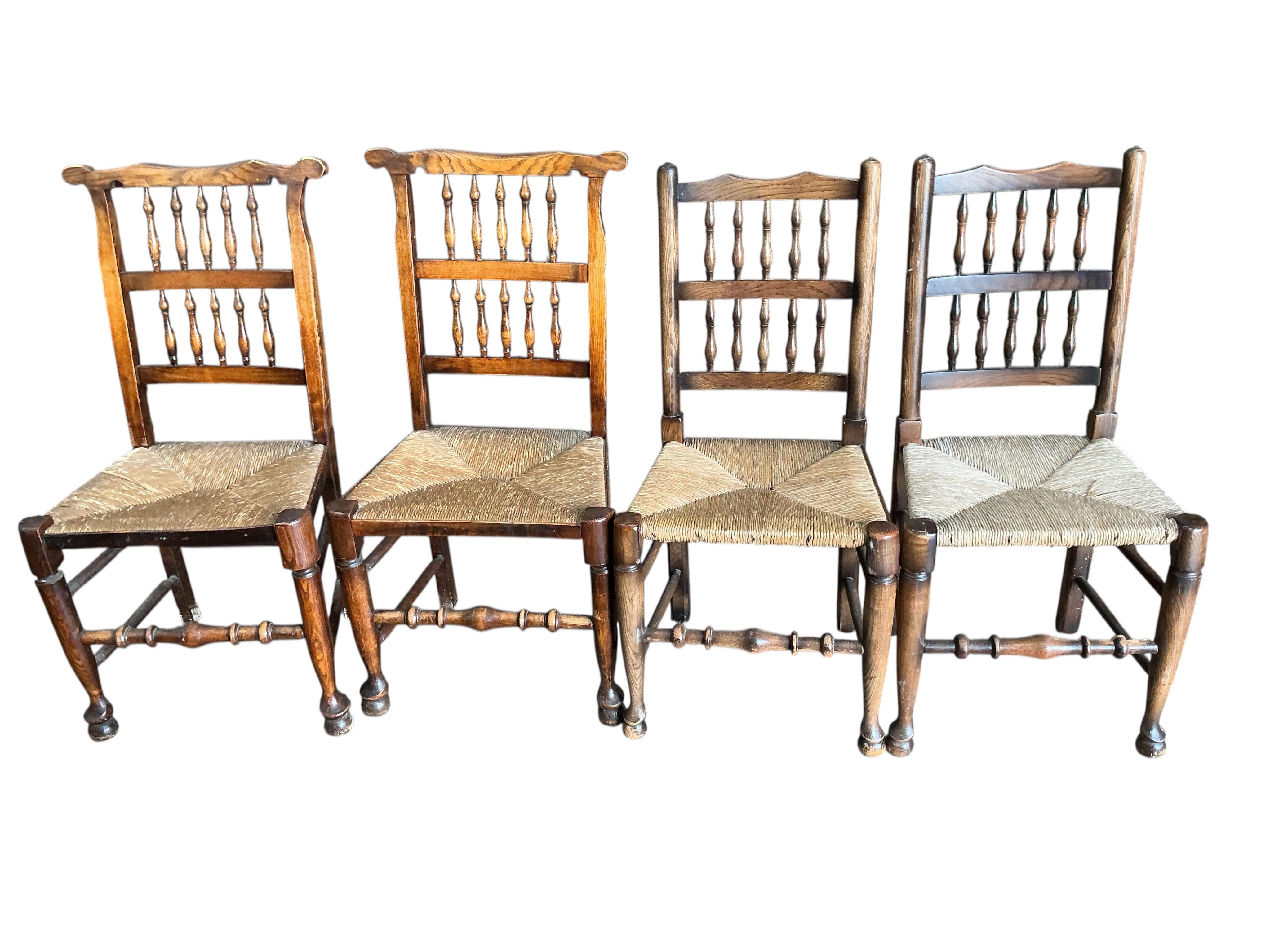 A harlequin set of eight (six plus two) Derbyshire style elm and beech rush seat spindle back dining chairs, two with arms